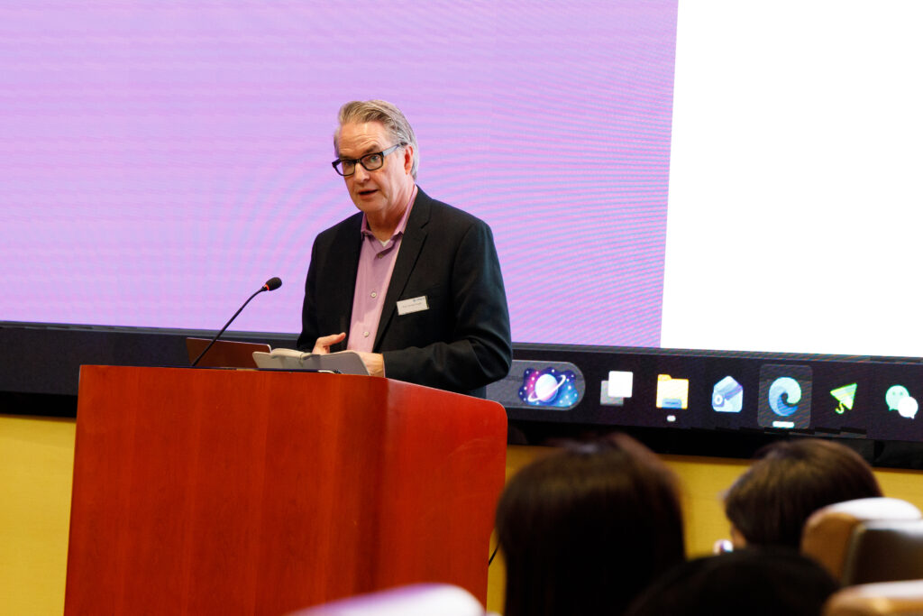 Emerson College Dean of Faculty Brooke Knight delivering a keynote address at Hong Kong Baptist University (HKBU)’s AI + COMM International Symposium