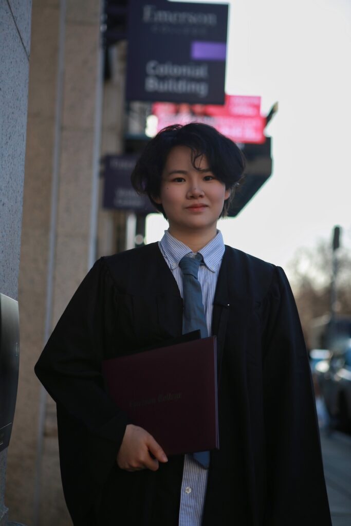 Photo of Echo Lu wearing commencement regalia