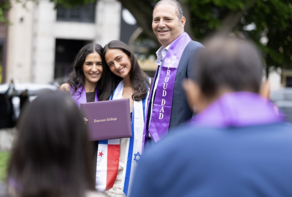 A graduate with two people