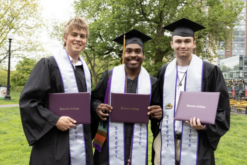 Three graduates pose for a photo