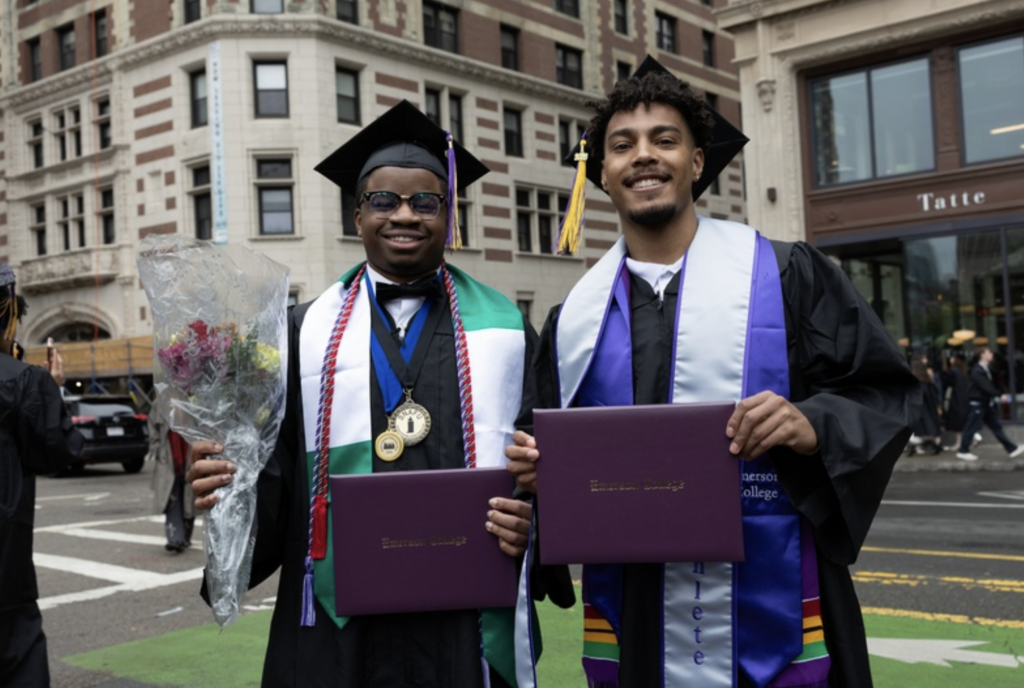 Two graduates pose for a photo