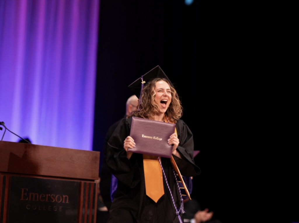 One person is excited after receiving their diploma on stage