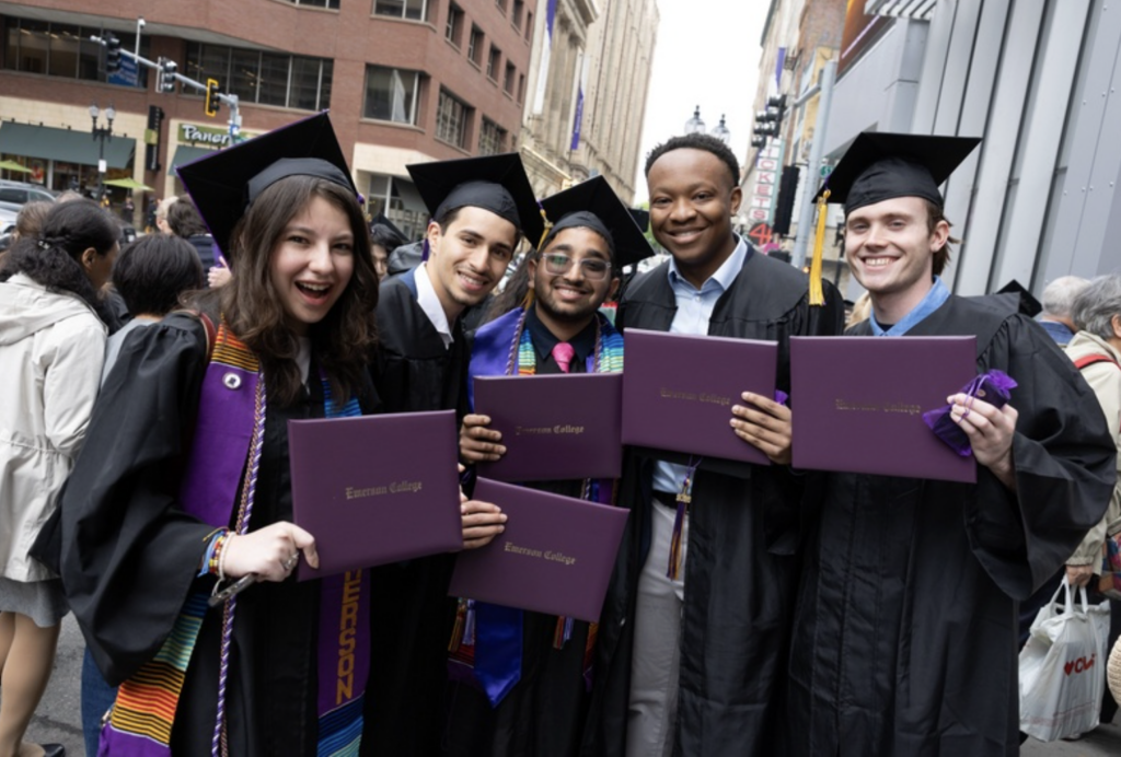 Five graduates hold up their diplomas for the camera