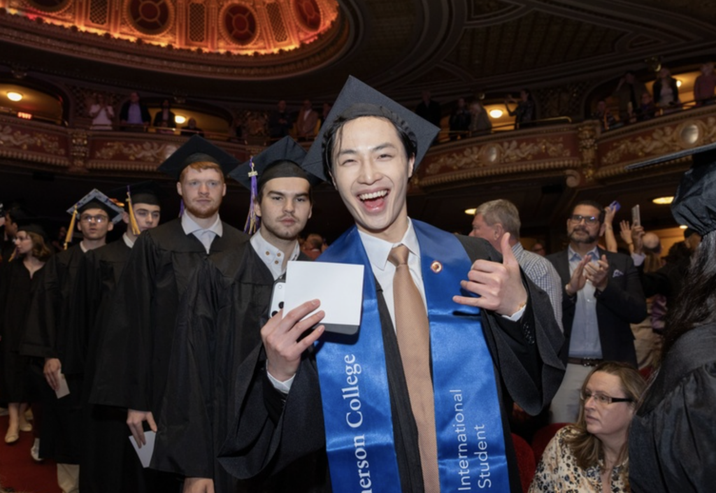 A person exuberantly smiles for the camera