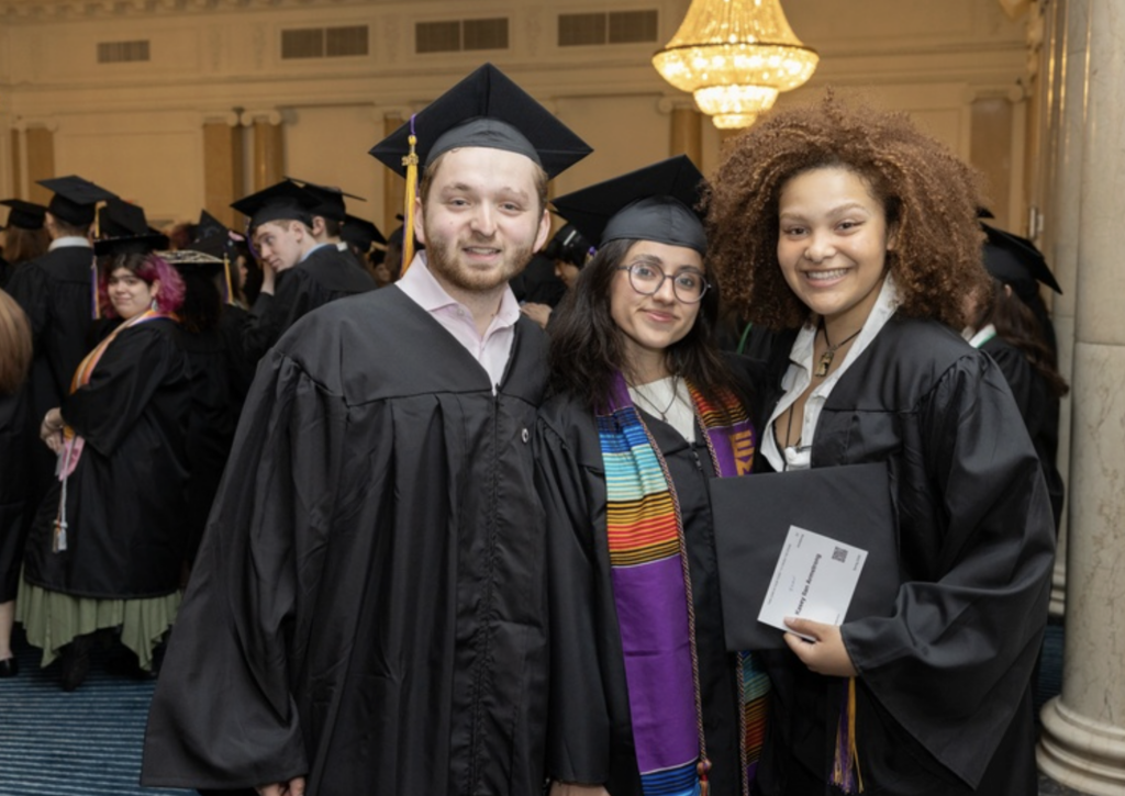 Three people pose for a photo