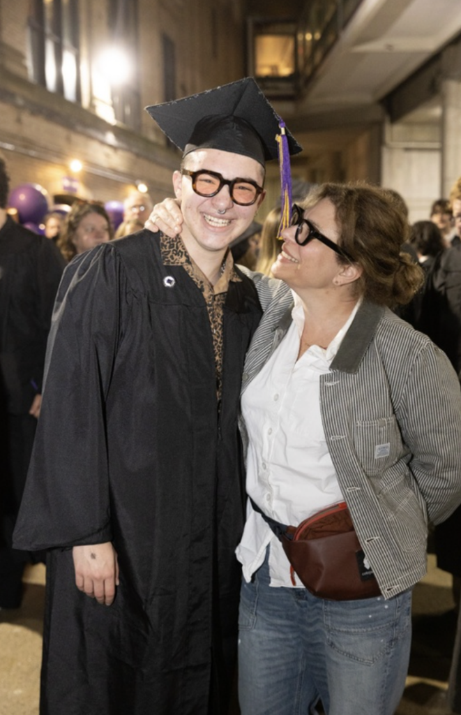 A parent looks proudly at their student