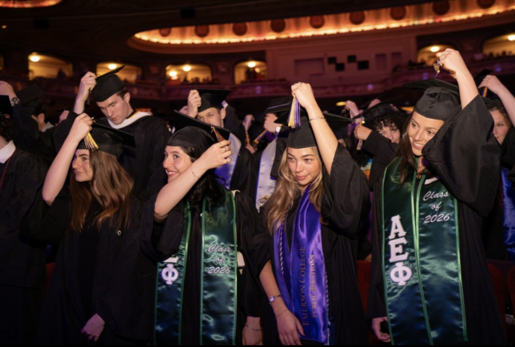 Students move their tassels to the other side of their cap