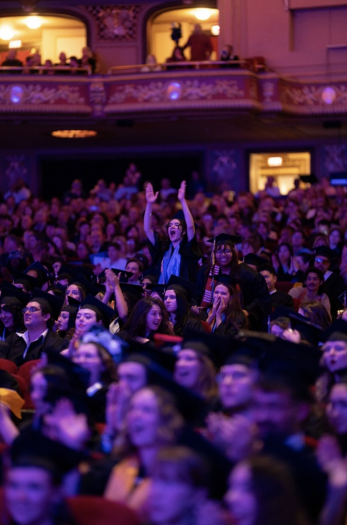 One student is standing and cheering