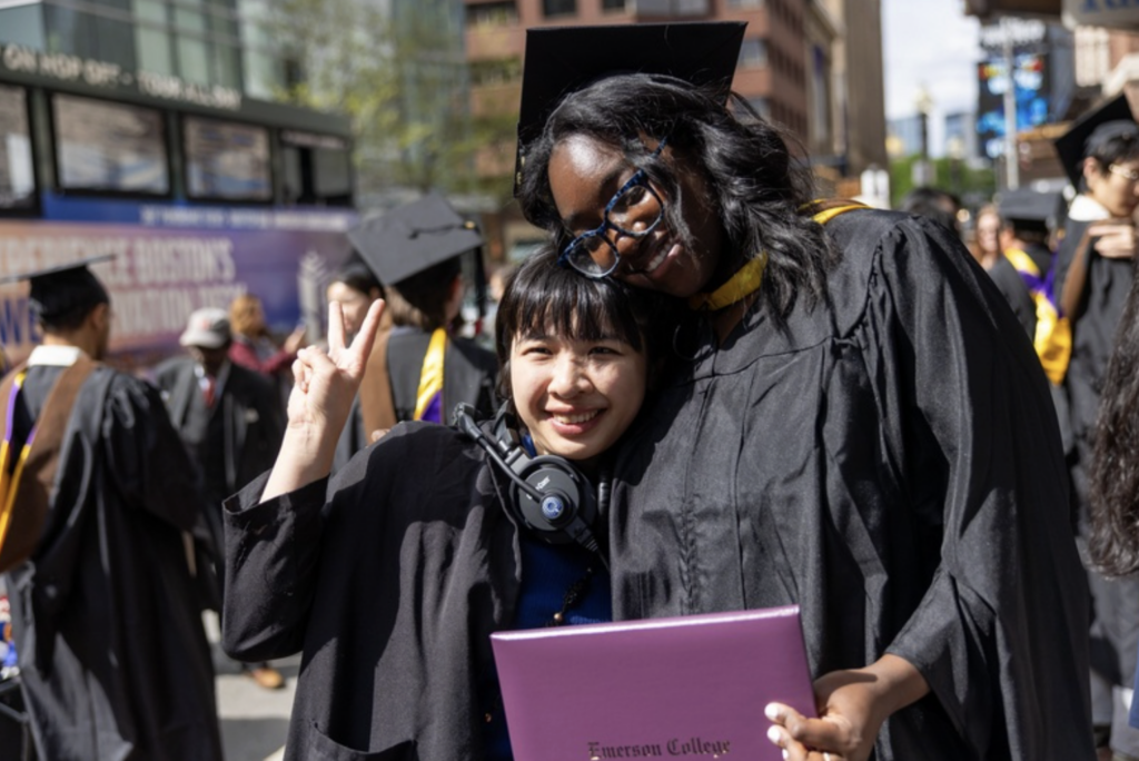 Two graduates pose for the camera
