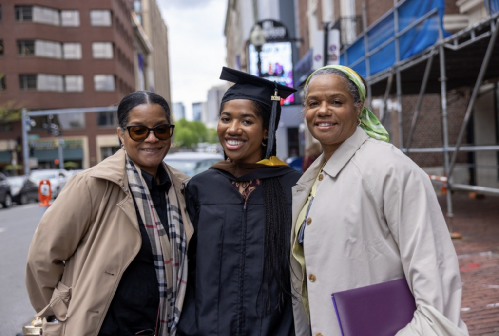 A graduate with two of their family members