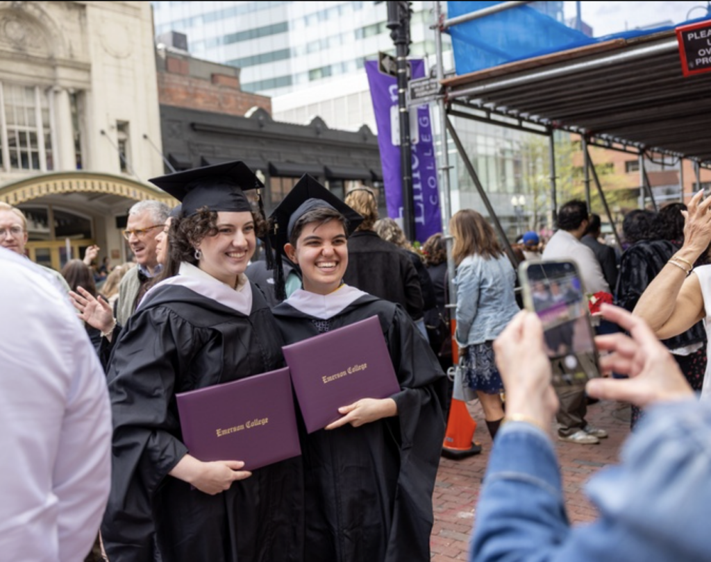 Two graduates pose for a photo