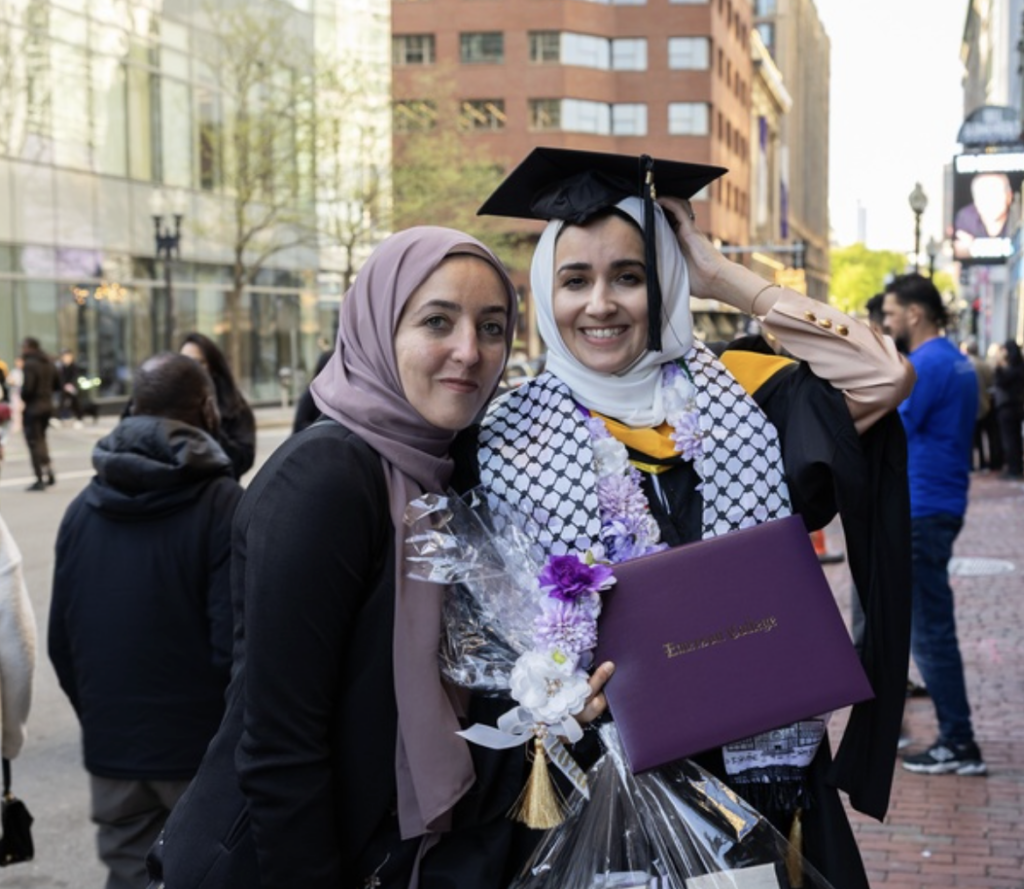 An alum with a family member pose for a photo